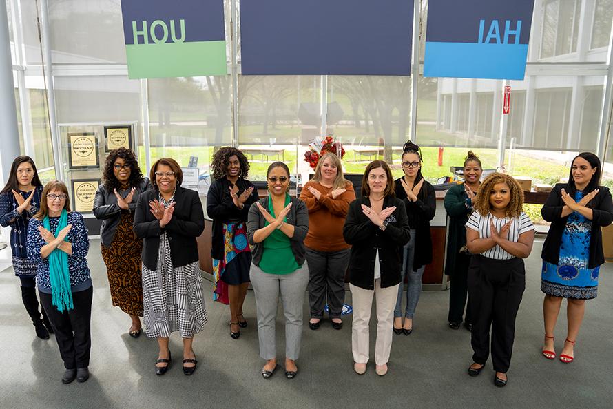 Houston Airports women gather to celebrate International Women's Day and cross their wrists in solidarity and recognition of the need to #Break the Bias.
