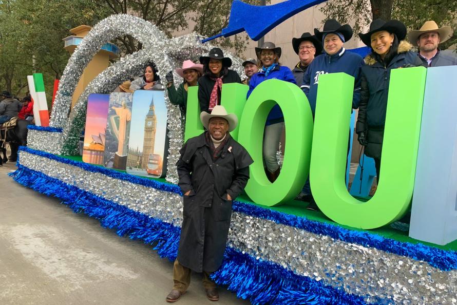 Houston Mayor Sylvester Turner poses with Houston Airports staff in front of the Houston Airports float